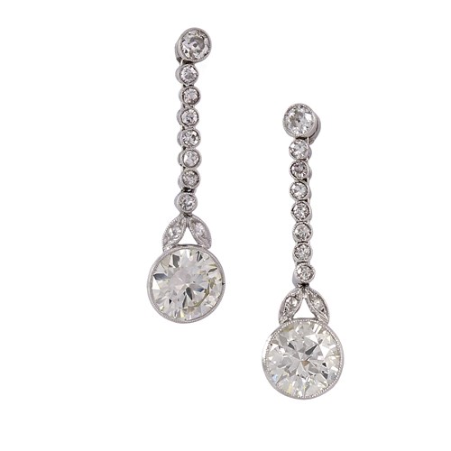 Pair of Art Deco diamond pendant earrings, c.1925, each hung with a principal round brilliant cut diamond of approximately 1.55ct,